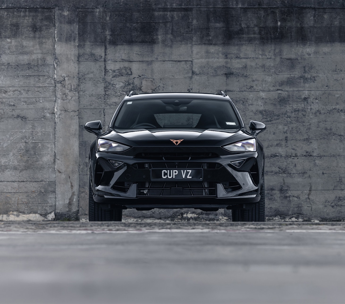 bird’s eye view of the century bronze matt cupra formentor parked on smooth cement.
