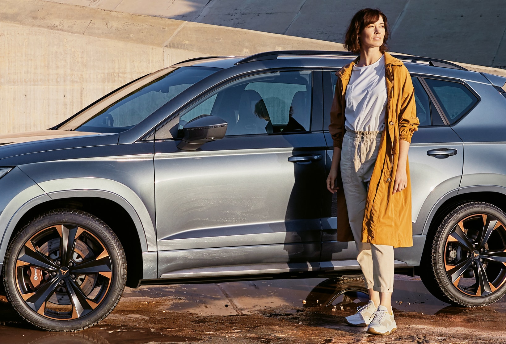 CUPRA Ateca with a woman beside it