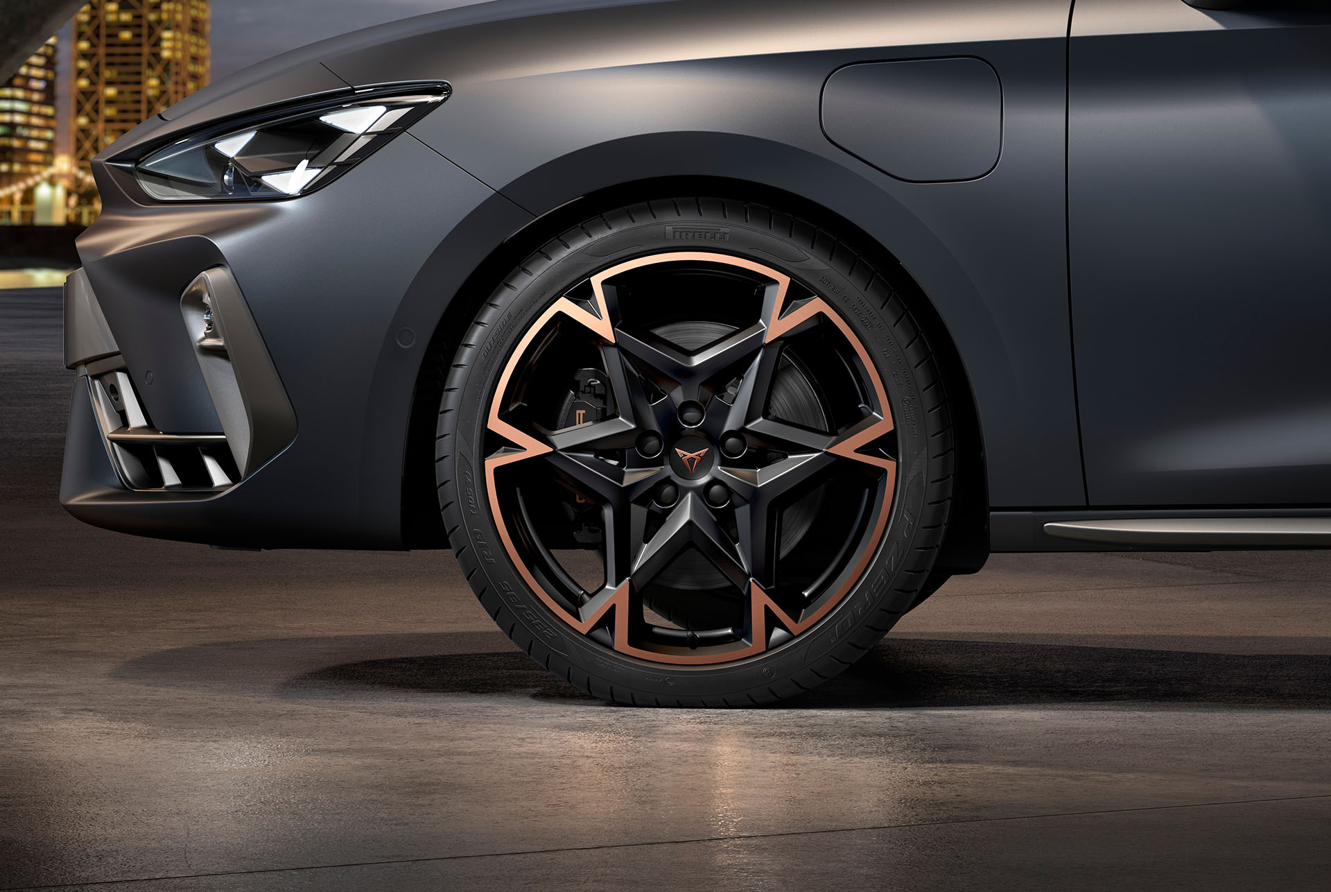 front side view of left machined alloy wheel in black and copper for the new cupra leon spotstourer 2025, tyres, signature headlights and grey body