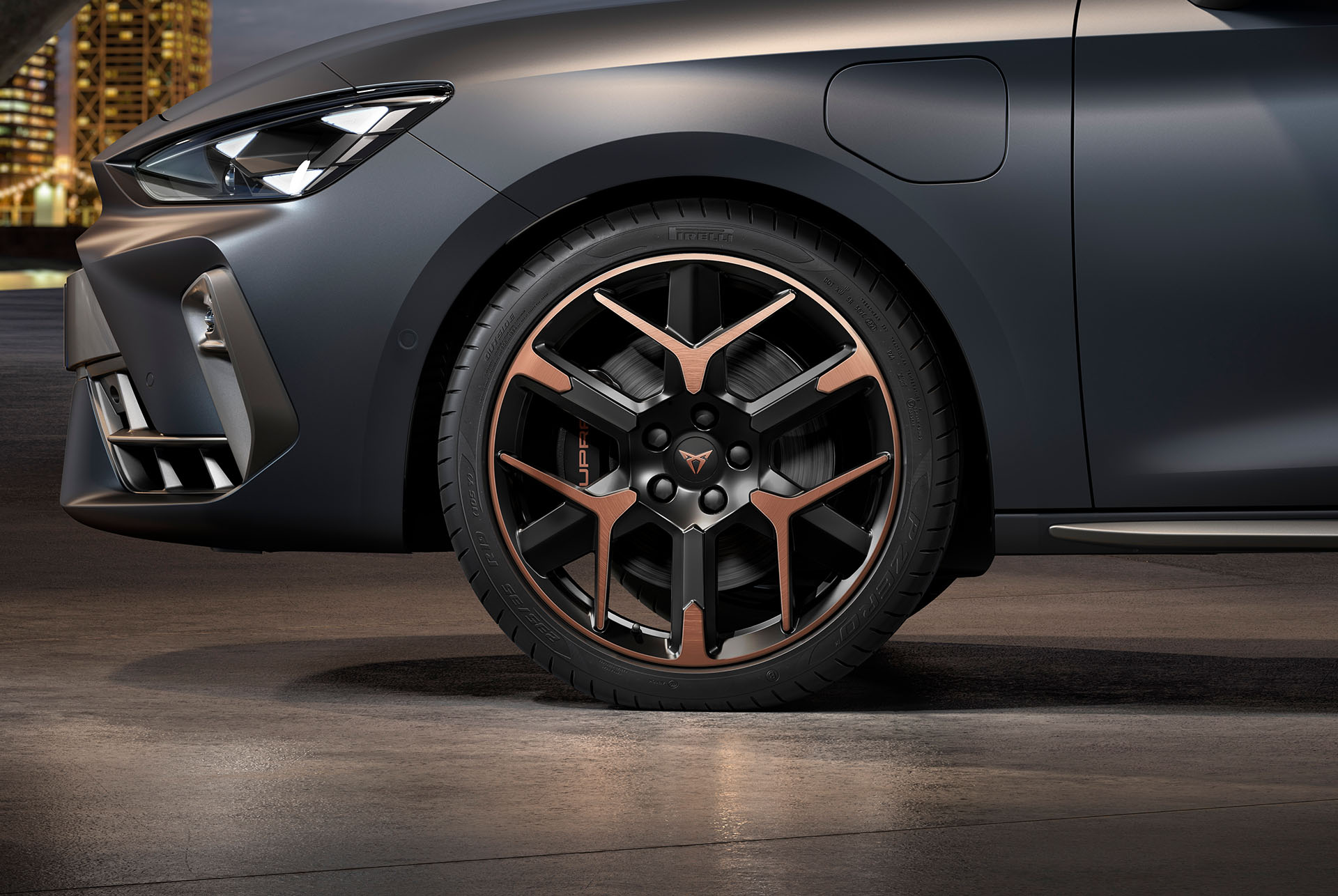 front side view of left forged alloy wheel in copper and black for the new cupra leon spotstourer 2025, tyres, signature headlights and grey body