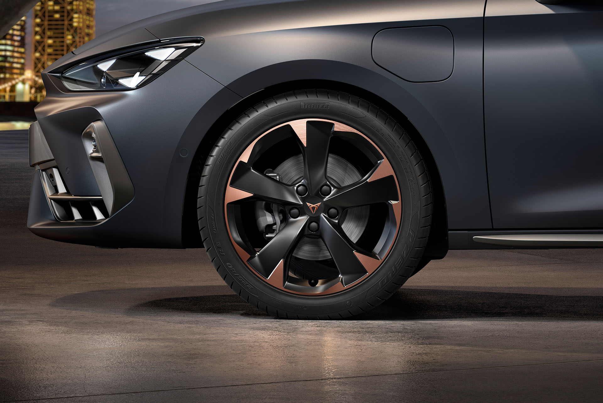 front side view of left mistral garbi copper machined alloy wheels for the new cupra leon sportstourer 2025, tyres, signature headlights and grey body