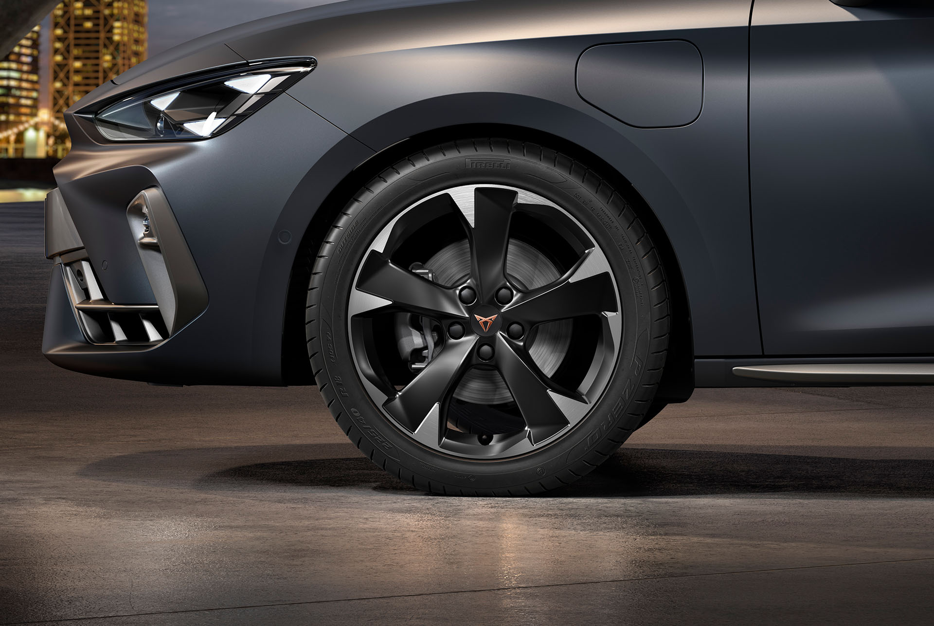 front side view of left machined silver garbi alloy wheel for the new cupra leon sportstourer 2025, tyres, signature headlights and grey body