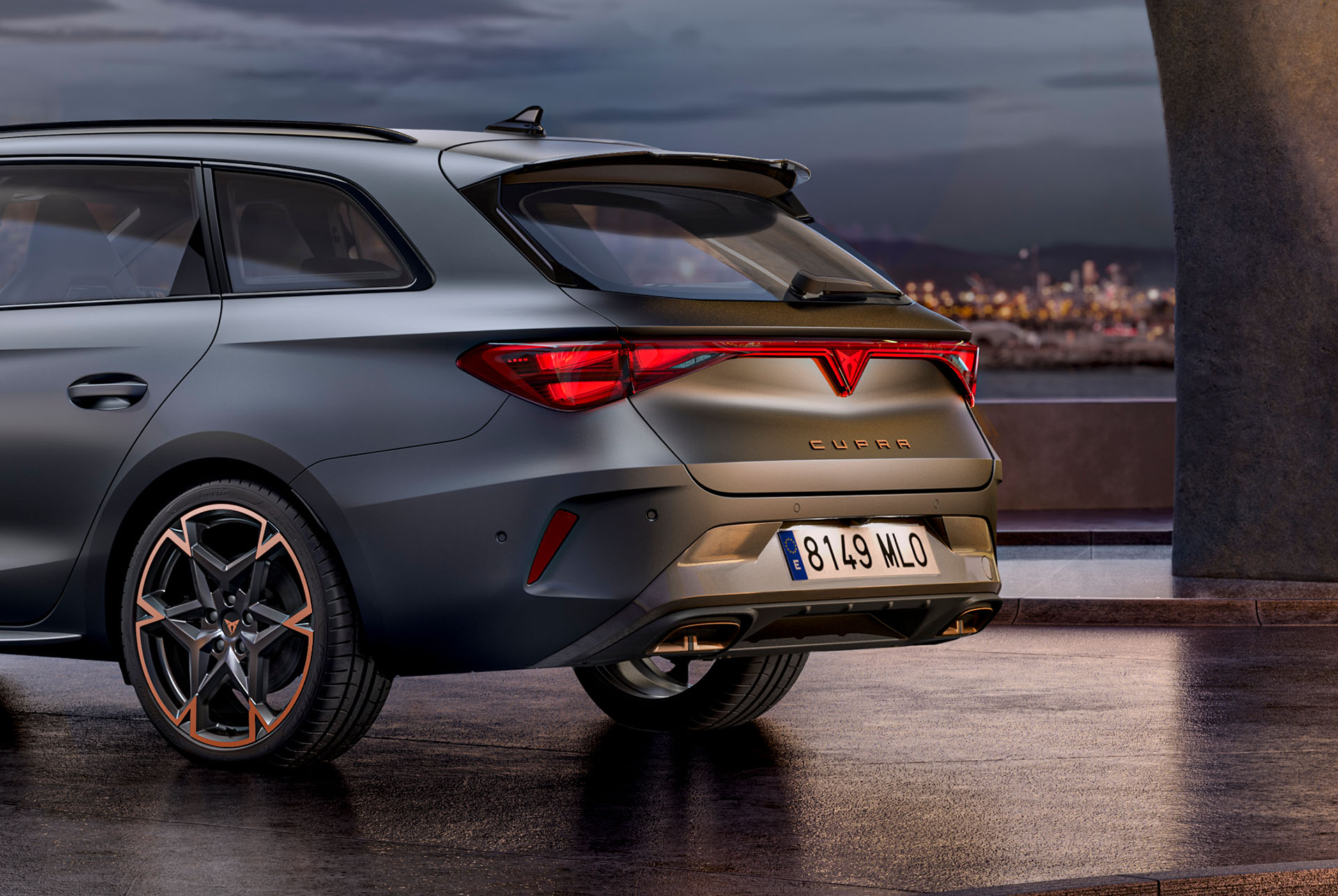 close up fo rear side view of new cupra leon enceladus grey matt 2025 hybrid car, copper accent forged wheels, concrete structure and city skyline