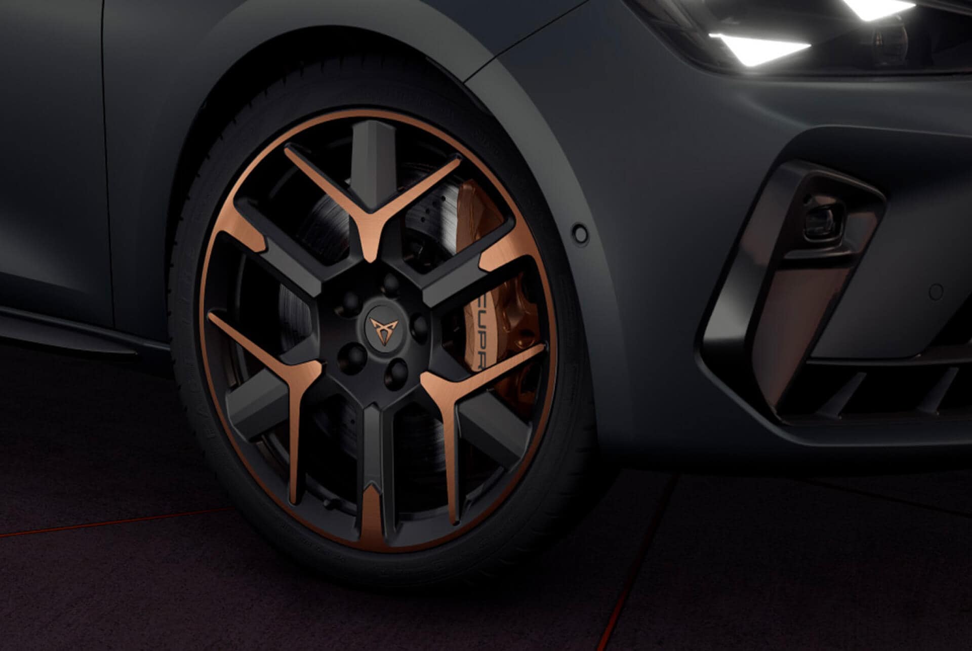 new cupra leon sportstourer 2025 close up of copper accent and black wheel and triangle eye cupra headlight, enceladus grey matt car body