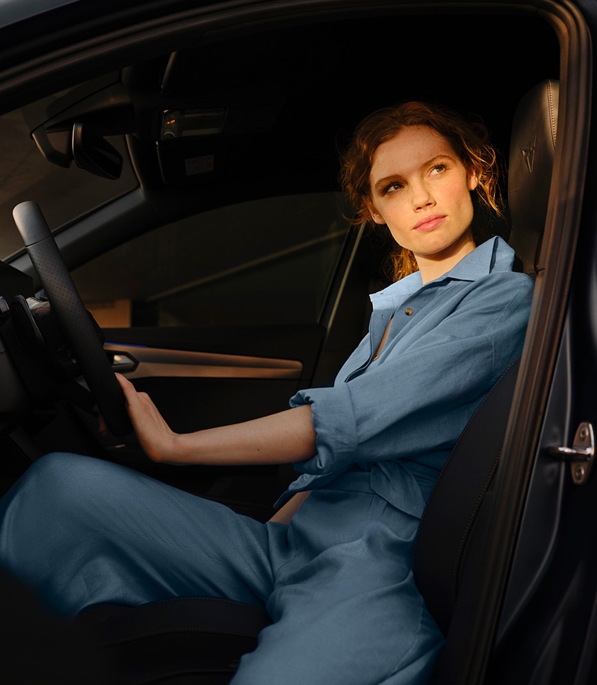  Girl sitting on the driver seat of a CUPRA