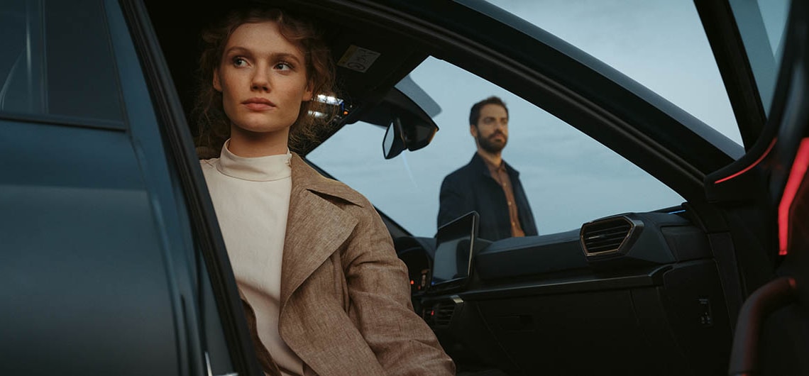 alexia putellas sitting in front of black cupra formentor vehicle